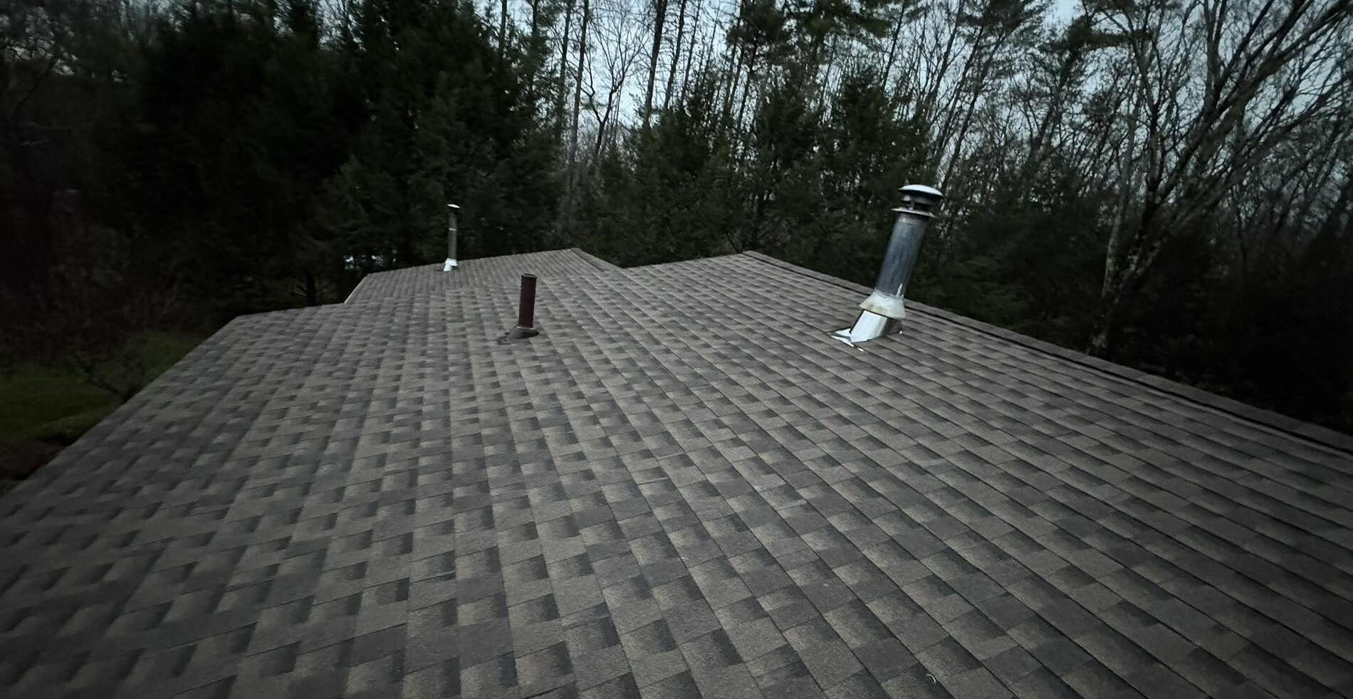 roof with grey shingles during the evening