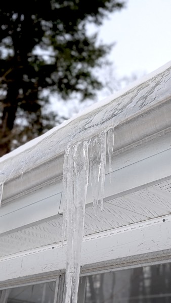 Close-up image of an ice dam on the edge of the roof