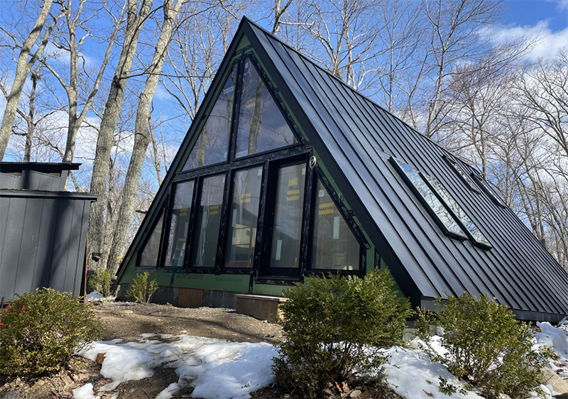 Upstate a-frame home with standing seam metal roof by Sheeley Roofing
