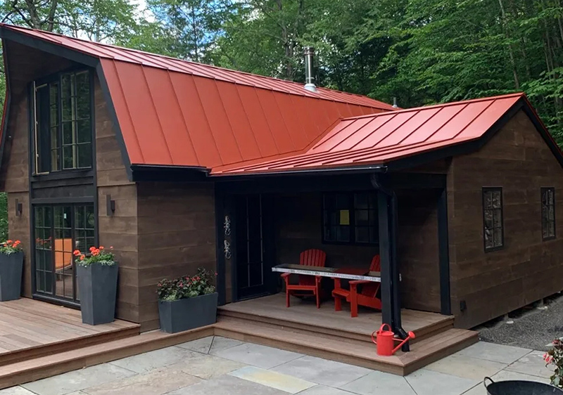 A-frame home with a bold red standing seam metal roof