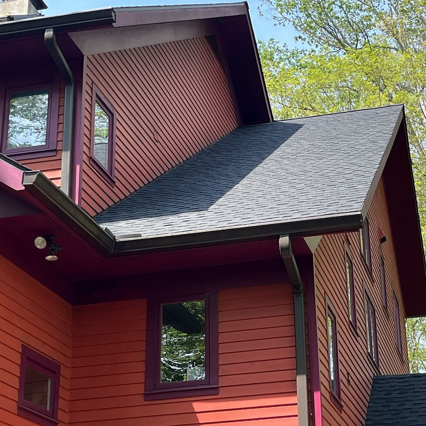 red house with dark grey shingles