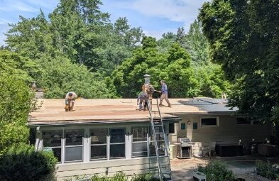workers on the roof of a house