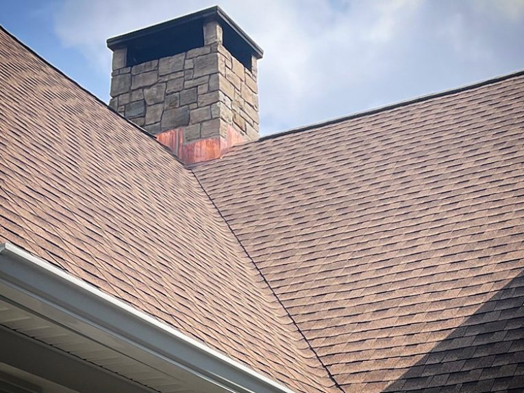 Corner view of a shingle roof, showing precise installation and seamless edges.
